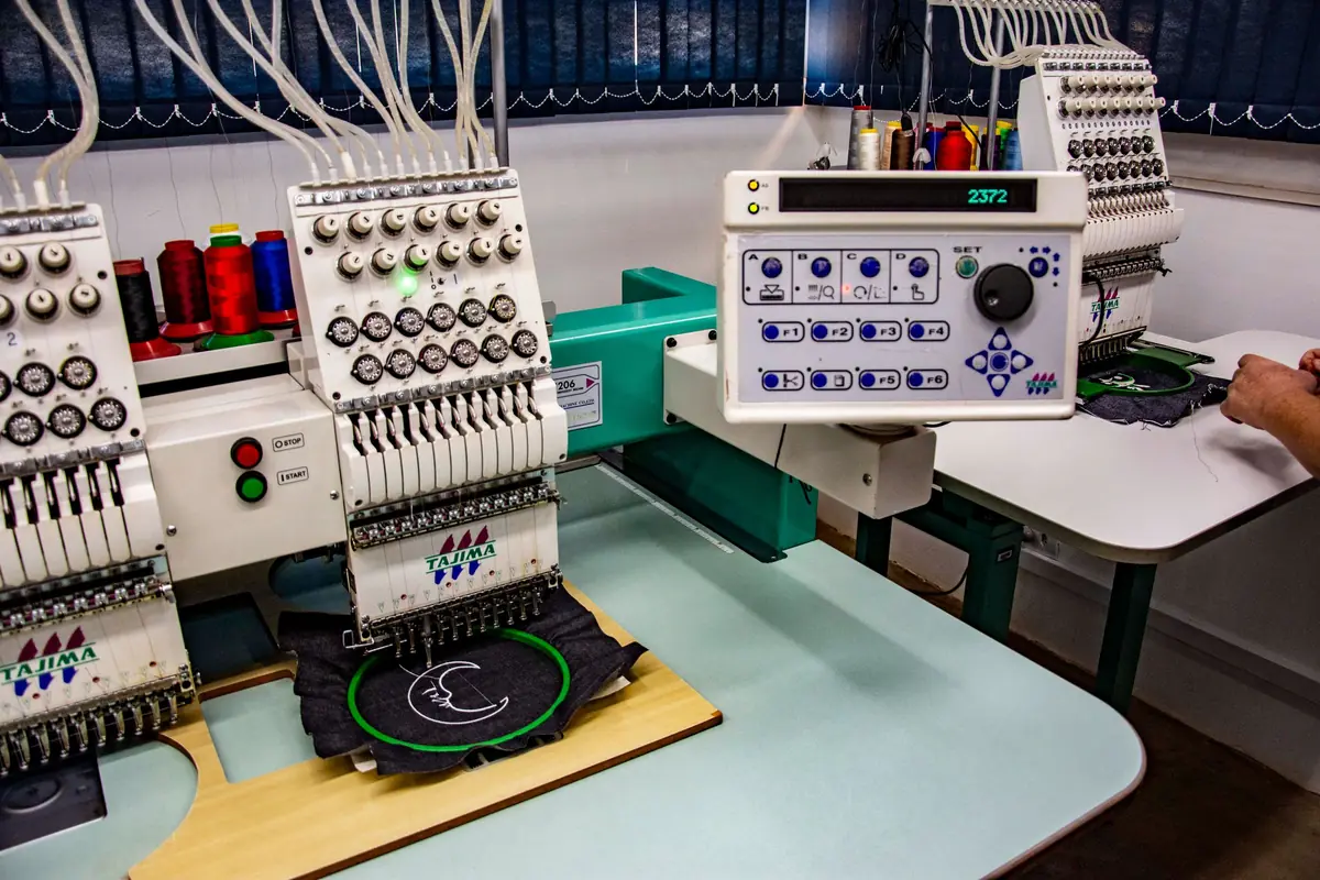 Multi-head embroidery machines personalising garments in a production workshop