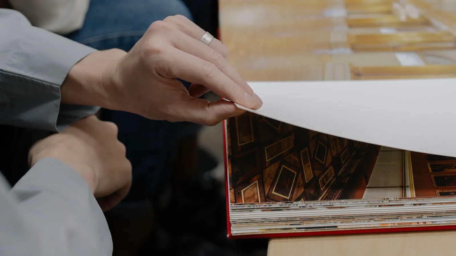 Print shop operator checking print quality on a printed page before it ships