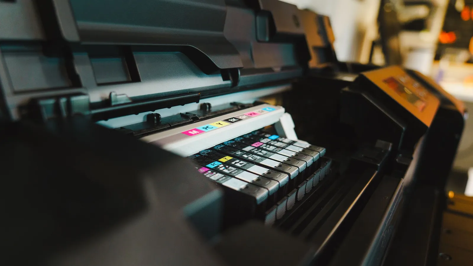 DTF gang sheet builder software concept: wide-format printer cartridges loading for a full transfer sheet run